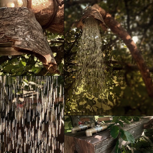 Outdoor-Dusche aus alten Hölzern und Messing-Armaturen unter Bäumen